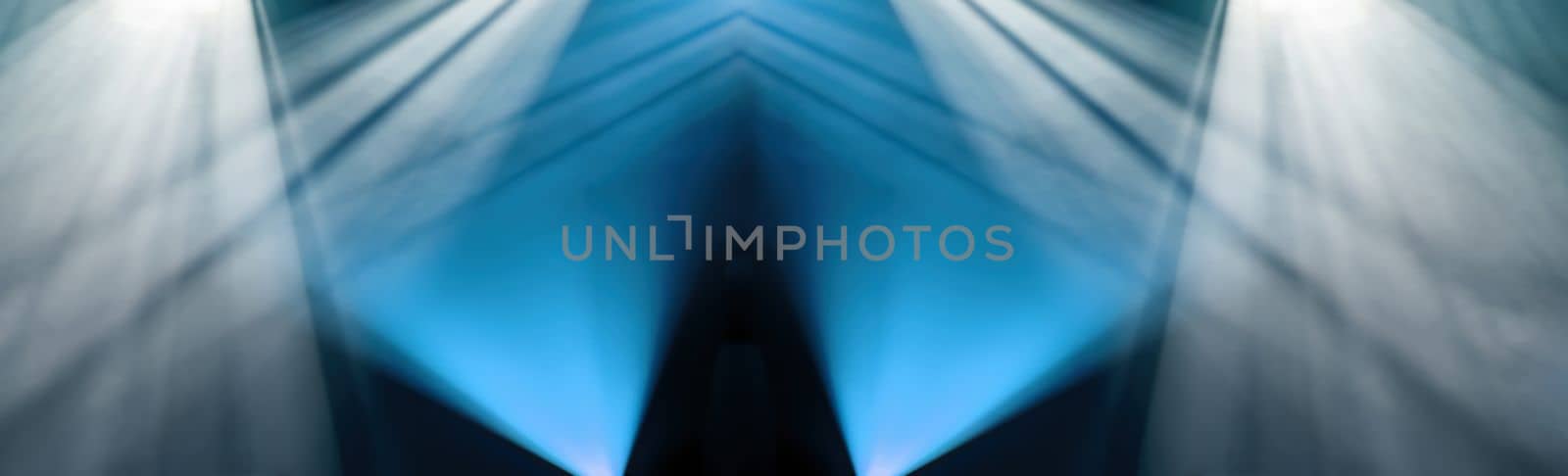 Abstract background of blue and white light of stage from spotlights projectors, panoramic view