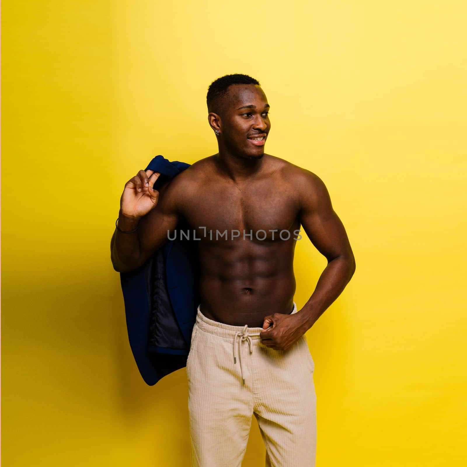 Smiling young african american man guy isolated on yellow background studio. People sincere emotion