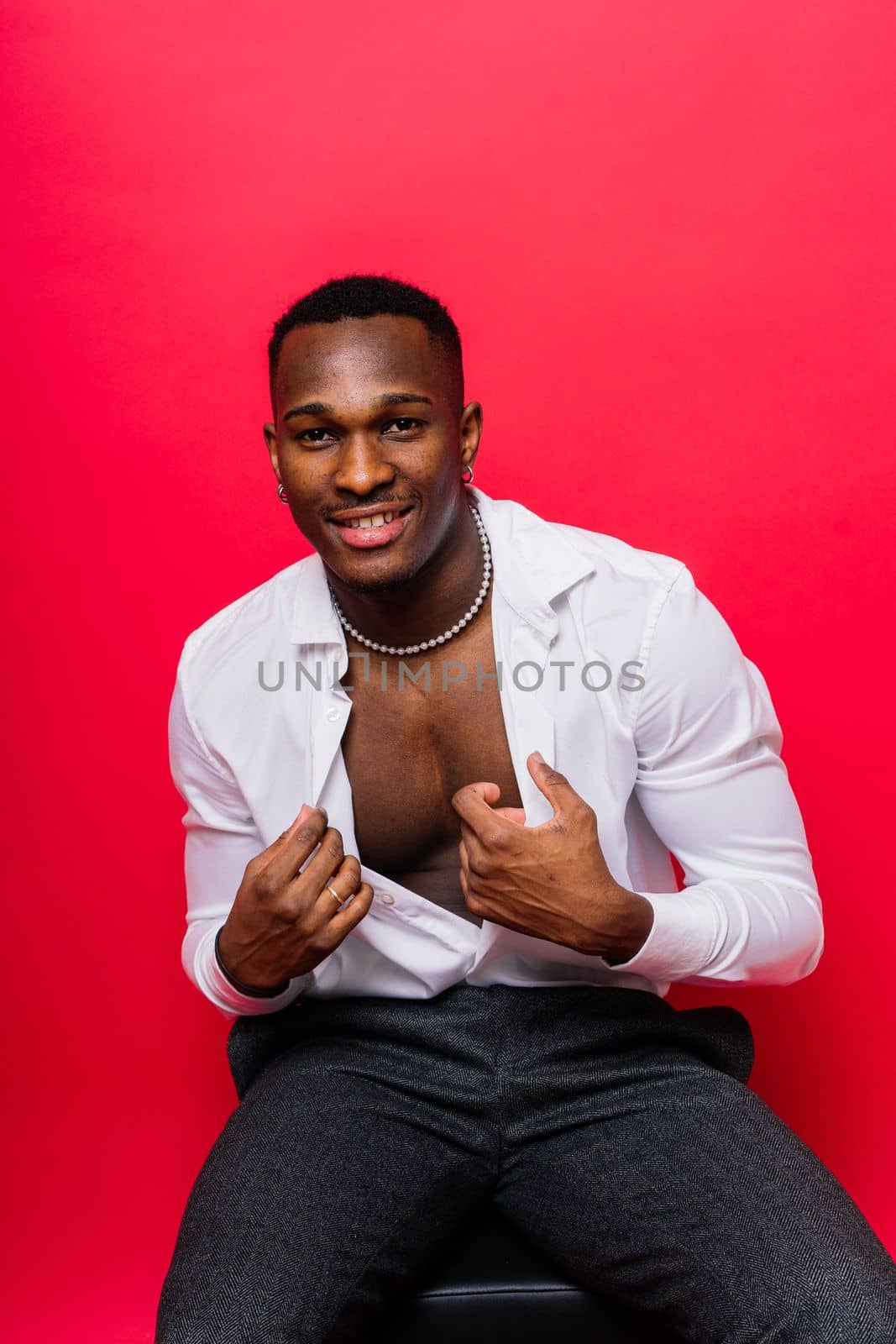 Smiling young african american man guy isolated on yellow background studio. People sincere emotions by Zelenin