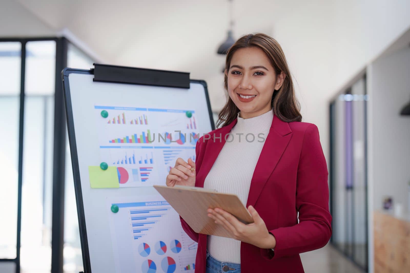 Portrait of Smiling asian business woman with laptop computer in office. Woman in suit at office.