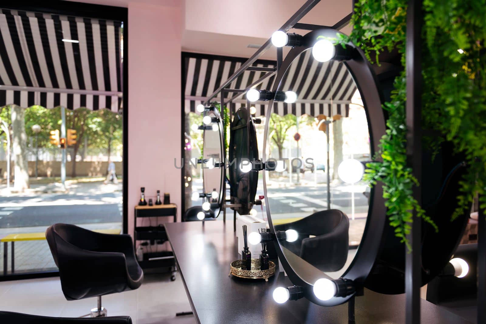 hairdressing area with mirrors and lights bulbs of a beauty salon, wellness and body care concept
