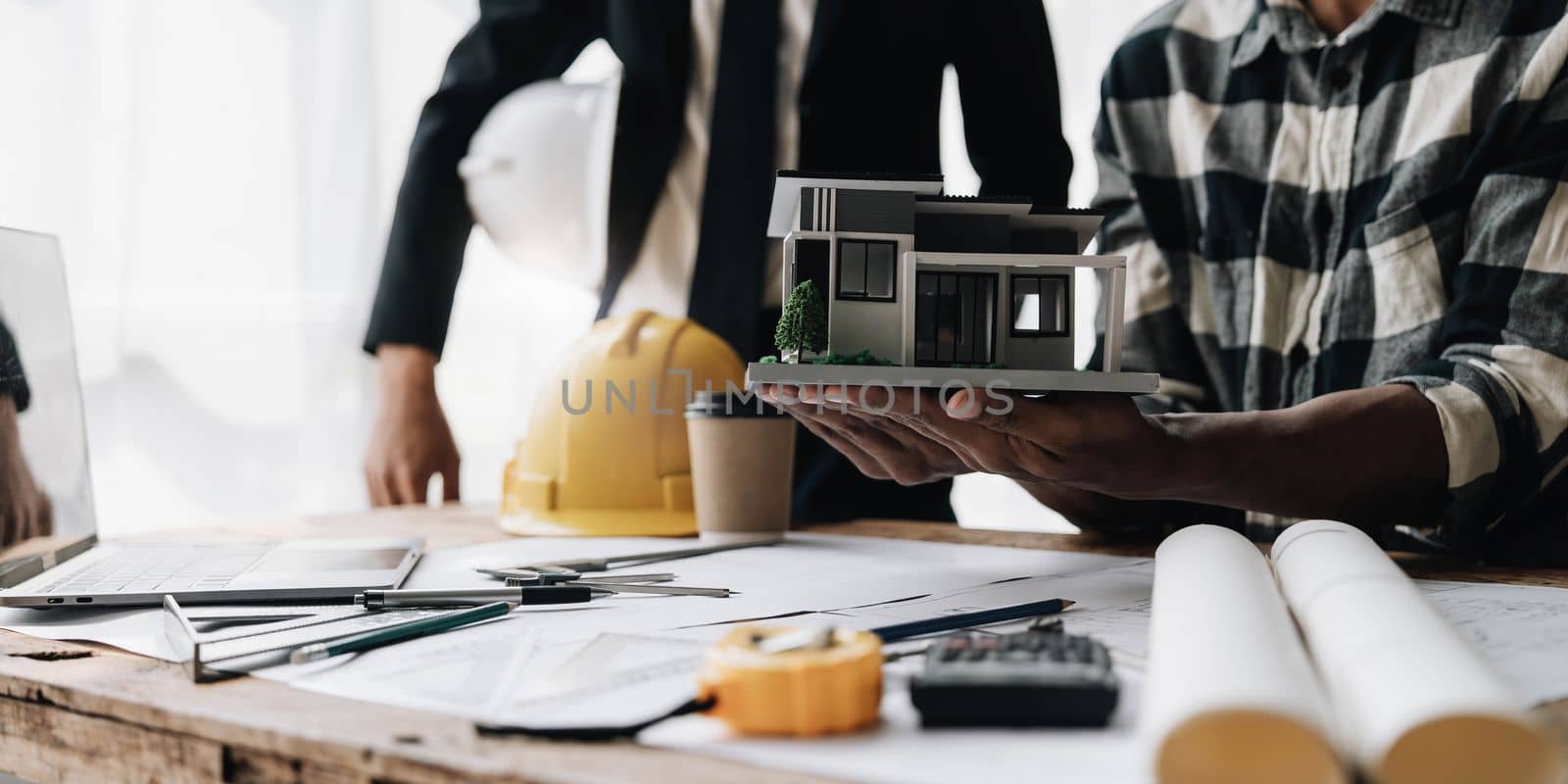 Civil engineer teams meeting working together wear worker helmets hardhat on construction site in modern city. Foreman industry project manager engineer teamwork. Asian industry professional team...