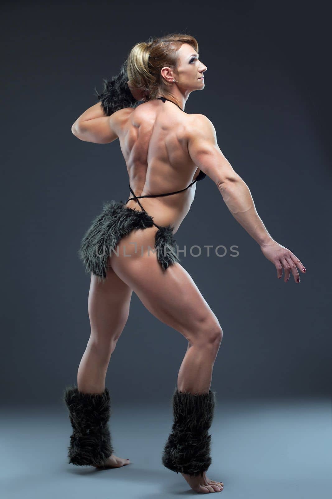 Heavy body builder woman in amazon fur costume