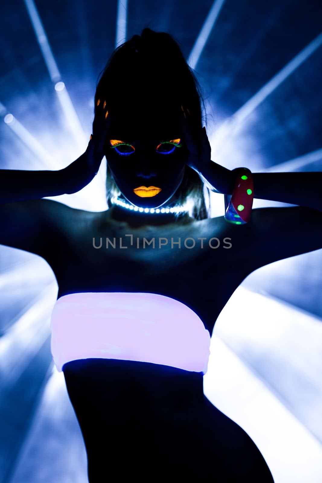 Girl with ultraviolet make-up disco dance in dark