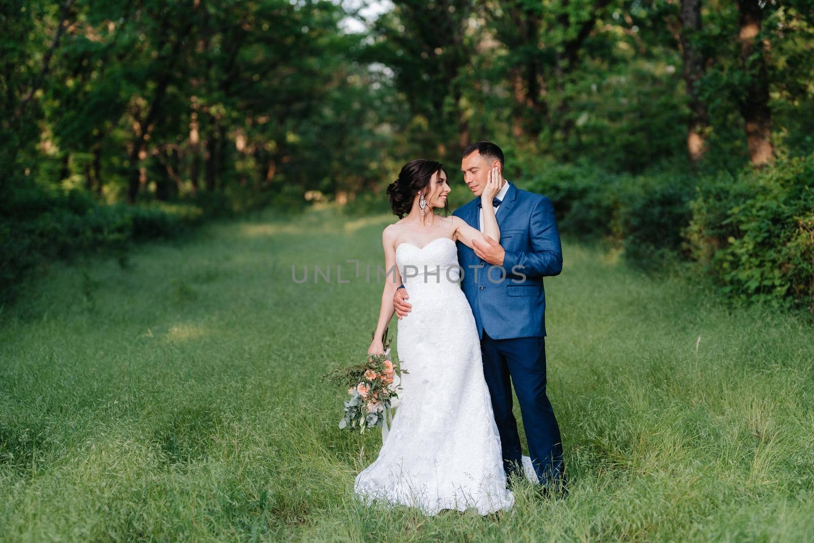 A couple in love a guy and a girl on a walk in the forest belt