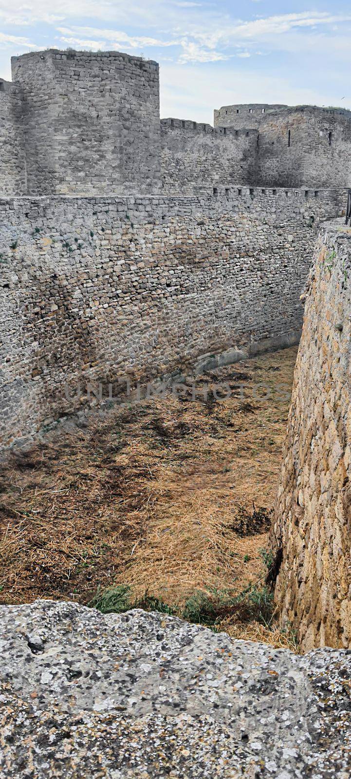 Ruined old fortress on the seashore. Blue sky. Architectural monument. Summer sea landscape. Rest.