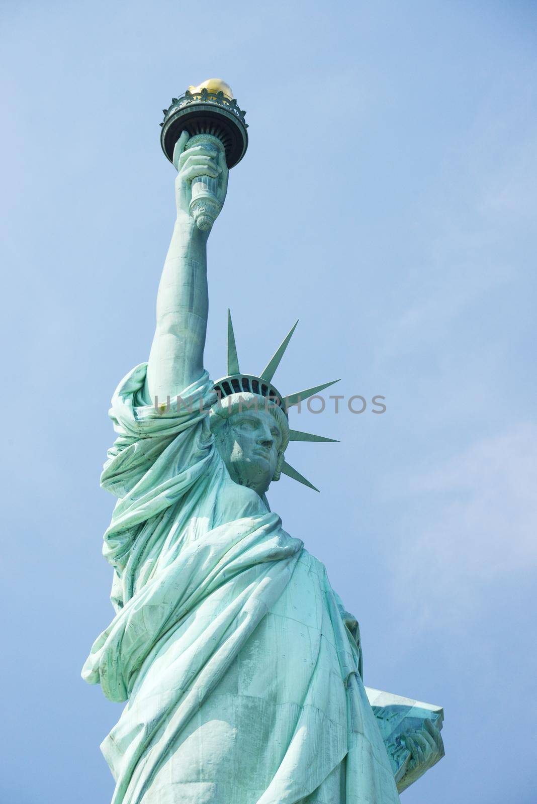 Liberty Statue, a landmark of new york city, with blue sky