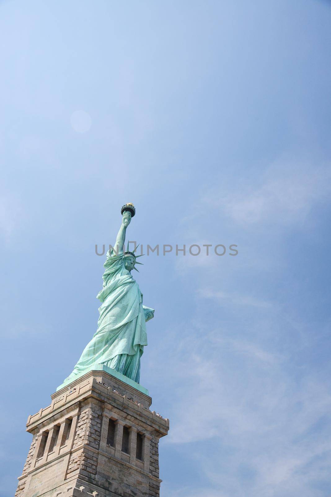 Liberty Statue, a landmark of new york city, with blue sky