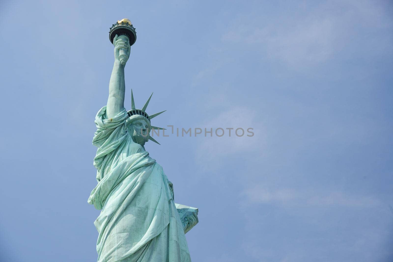 Liberty Statue, a landmark of new york city, with blue sky