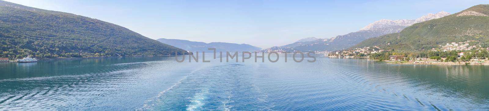 Panoramic view of Bay of Kotor from the sea surrounded by mountains in Montenegro, one of the most beautiful bay in the world.