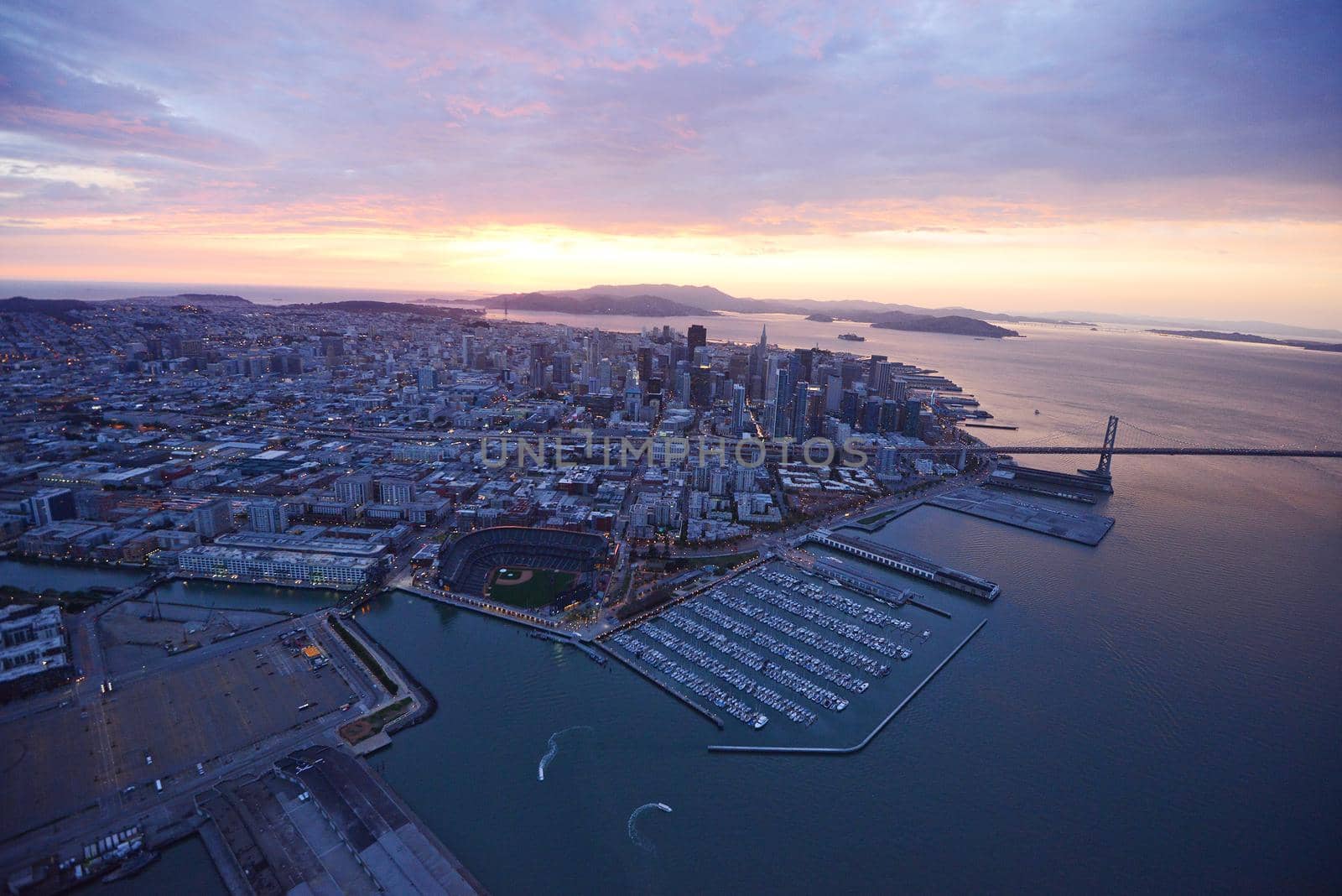 an aerial view of downtown san francisco with pier during sunset