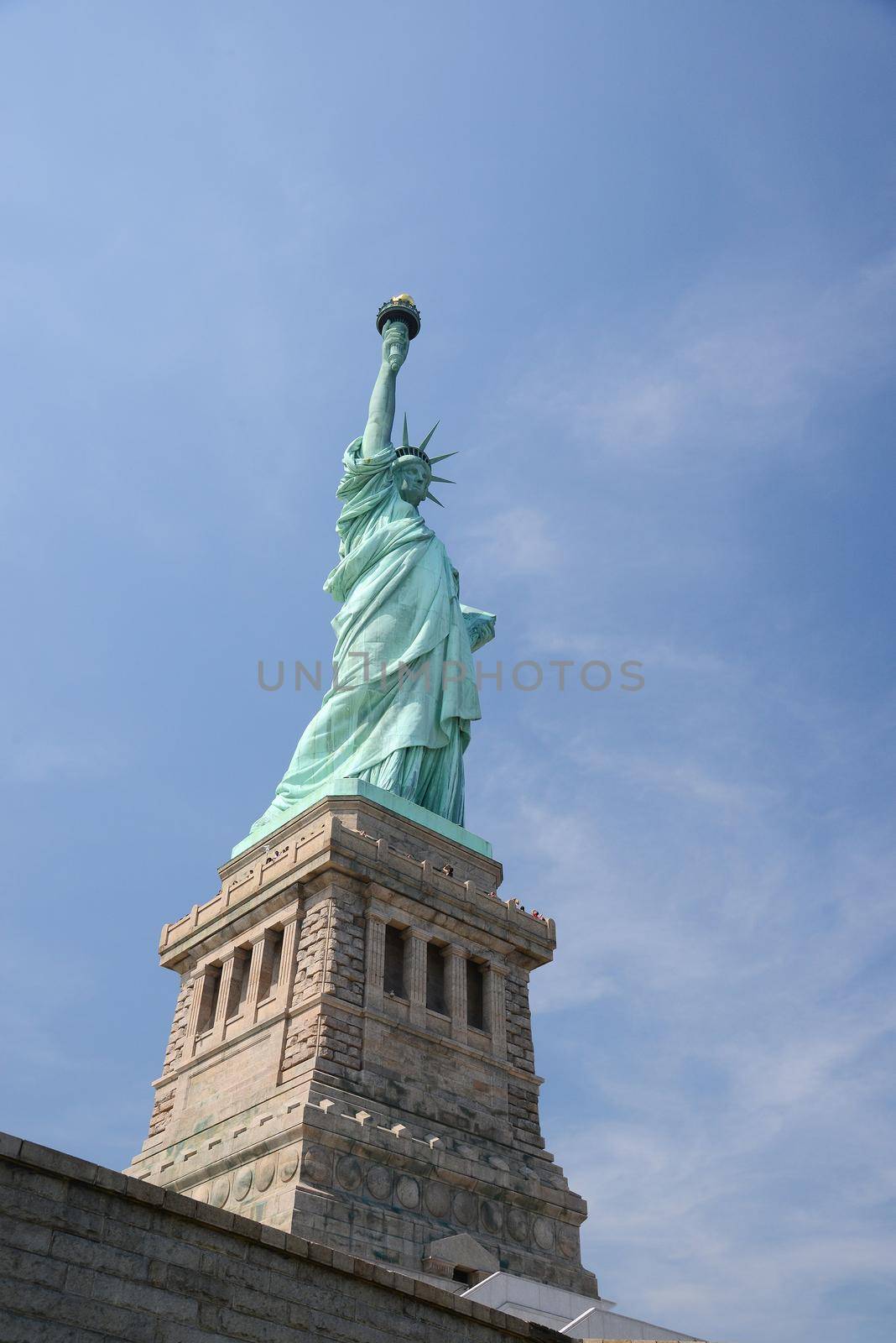 Liberty Statue, a landmark of new york city, with blue sky