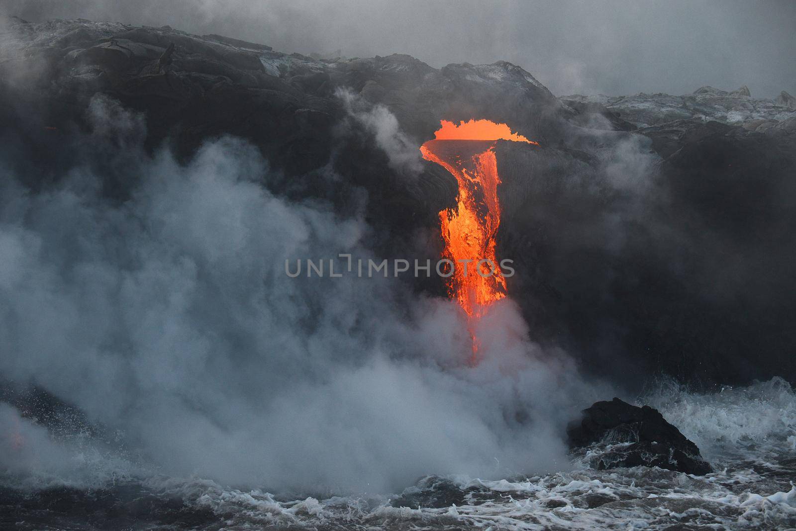 lava flow to pacific ocean at big island, hawaii