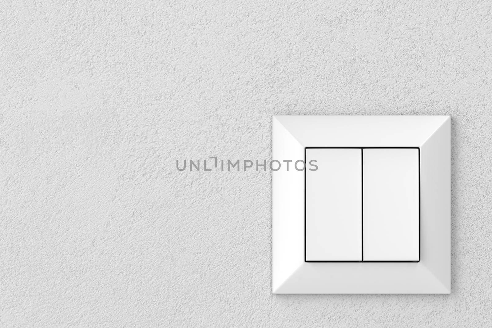 Double light switch on a gray wall, front view