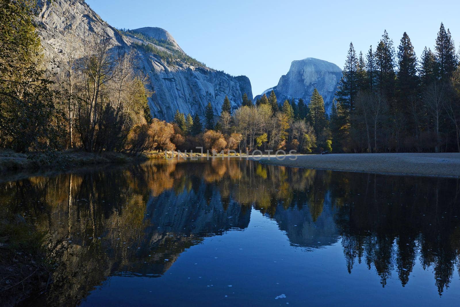 a reflection of half dome of yosemite over merced river