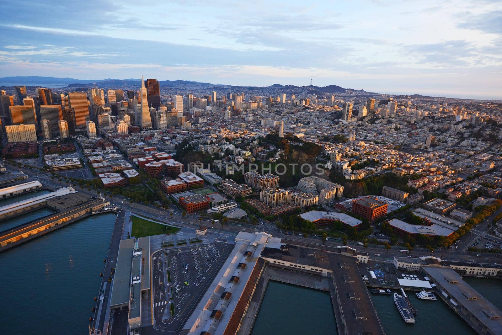 an aerial view of downtown san francisco with pier during sunset