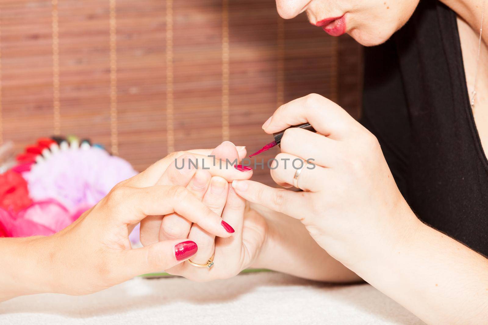 Laying nail polish on a woman's hands