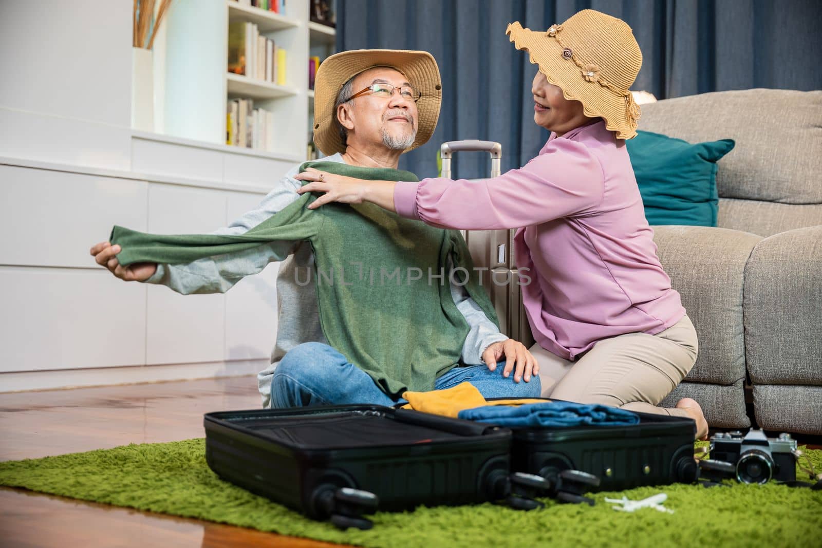 Asian couple old senior marry retired couple smiling prepare luggage suitcase arranging for travel by Sorapop