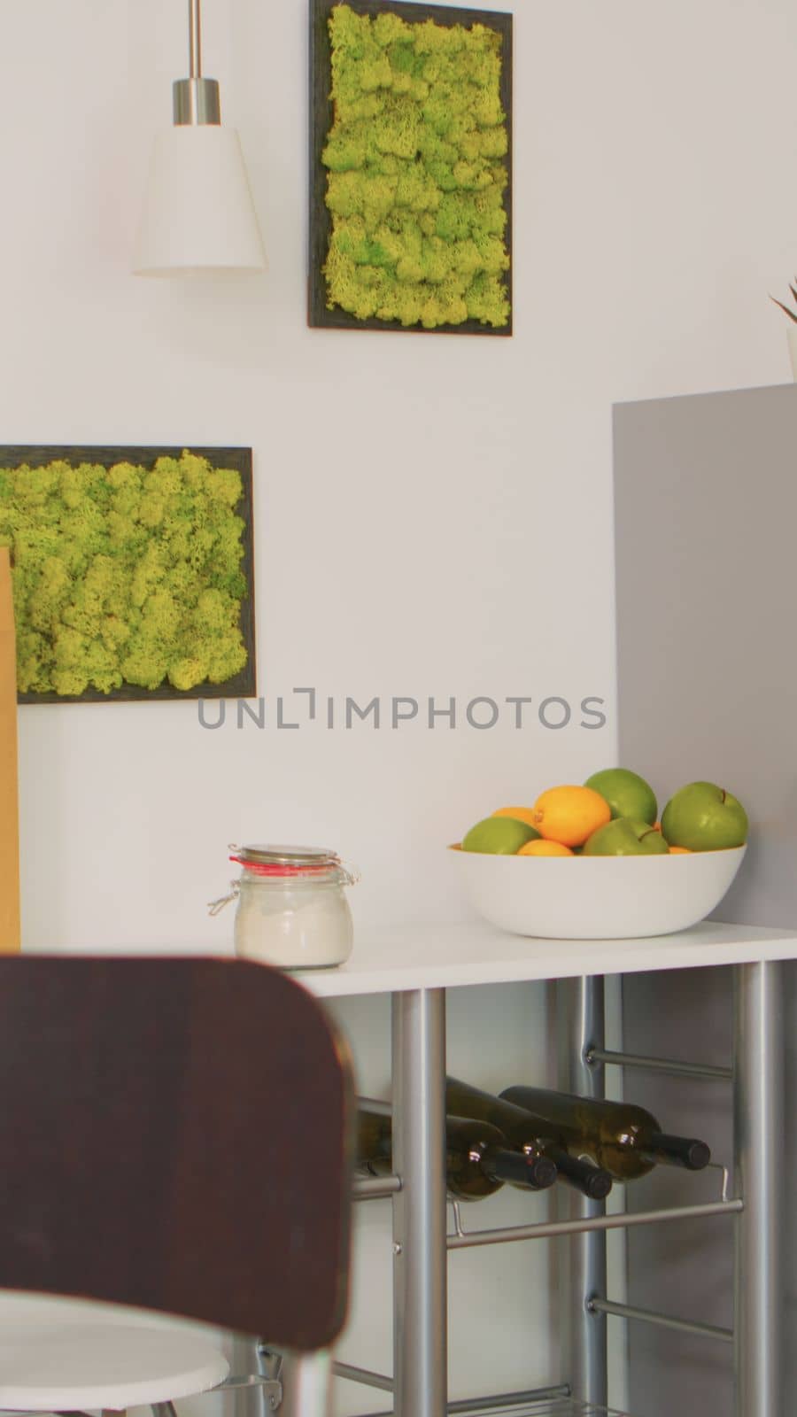 Bowl with freshs fruits in empty kitchen. Modern dining room with coffee machine in cozy interior with technology and furniture, decoration and architercture, comfortable room