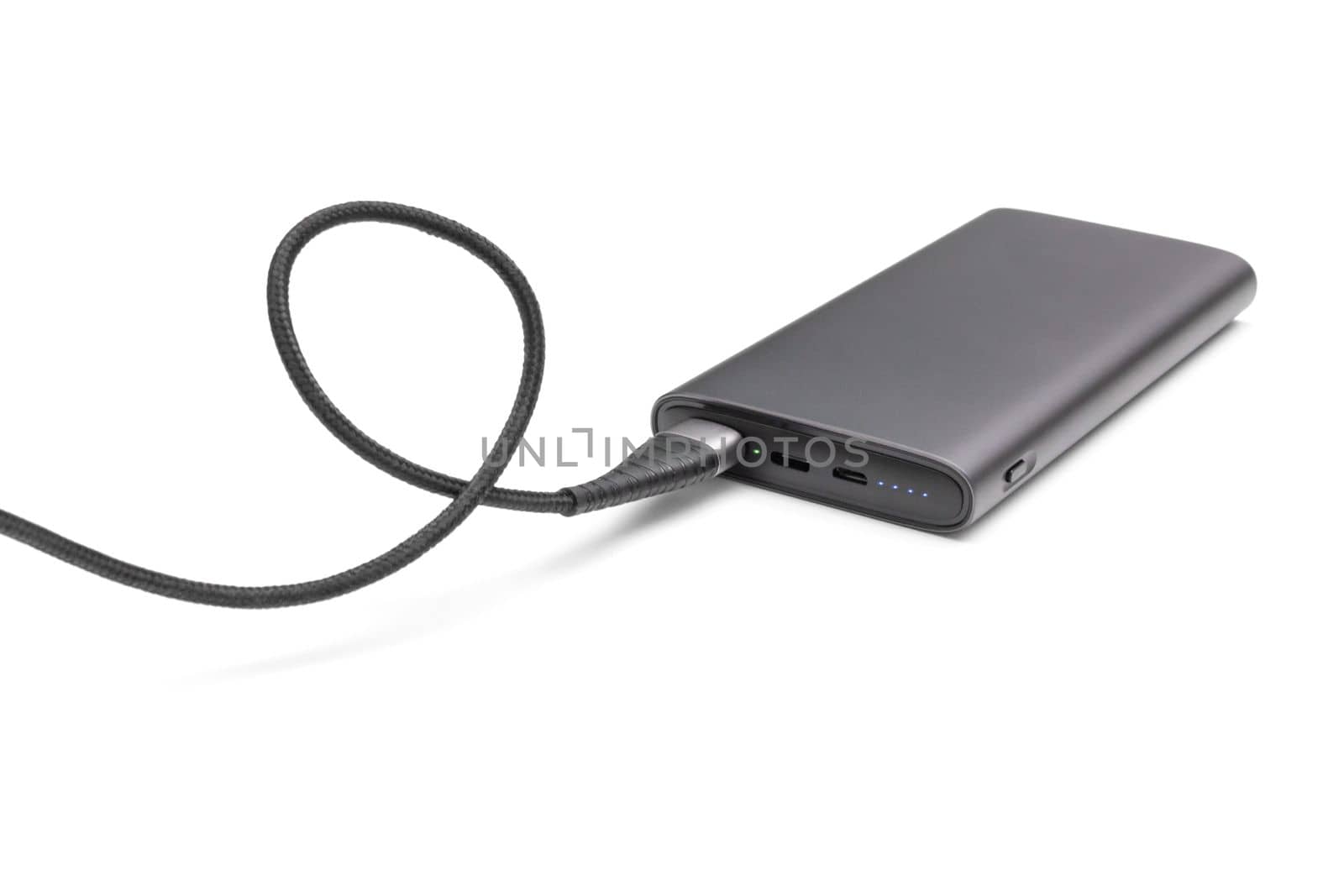 Fully charged portable powerbank with cable and two usb outputs isolated on a white background. Powerbank for charging mobile devices.
