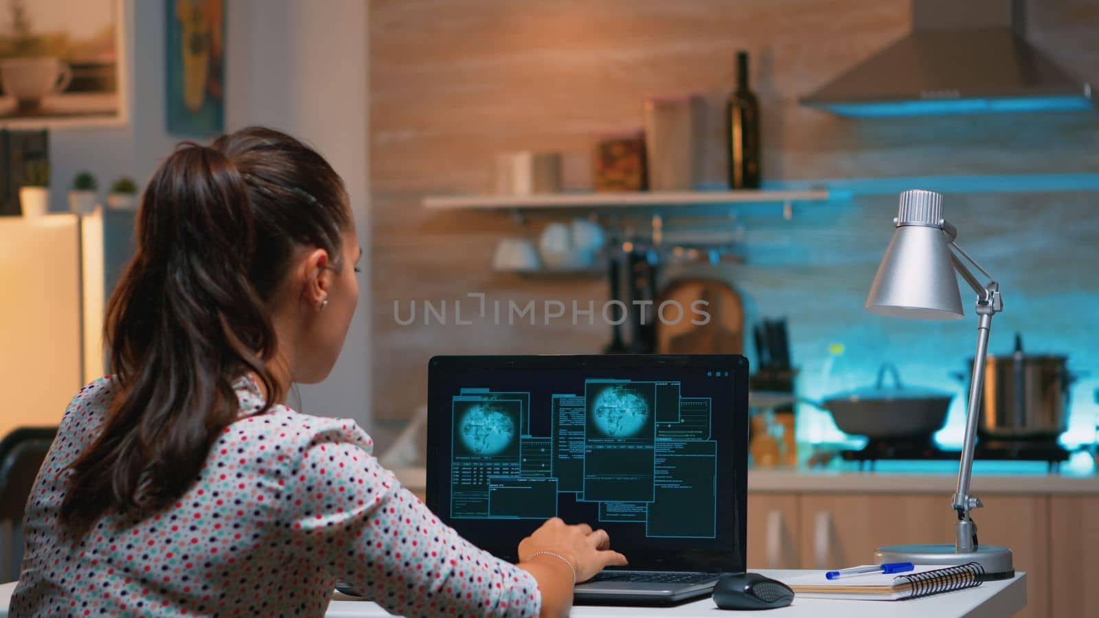 Hacker woman finishing succesfully hacking company system stealing database company. Programmer writing a dangerous malware for cyber attacks using performance laptop during midnight.