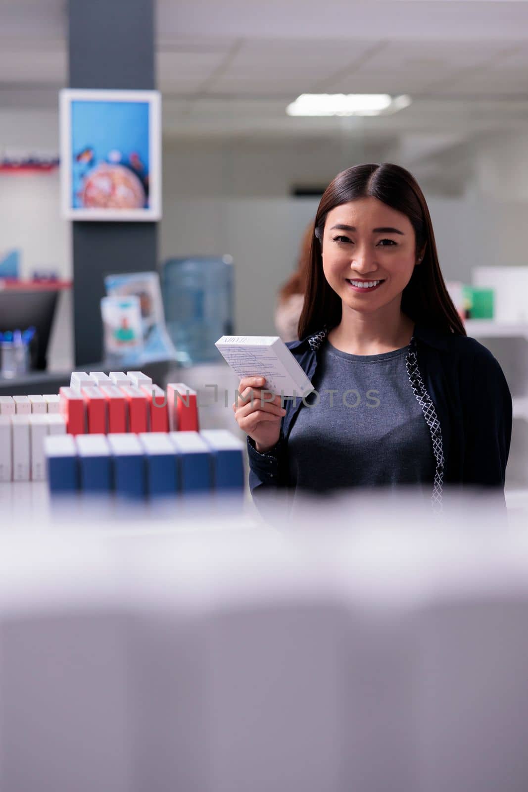 Woman customer looking at vitamin products for healthy lifestyle during pharmaceutical shopping in drugstore. Asian client reading medical prescription, buying supplements to cure illness