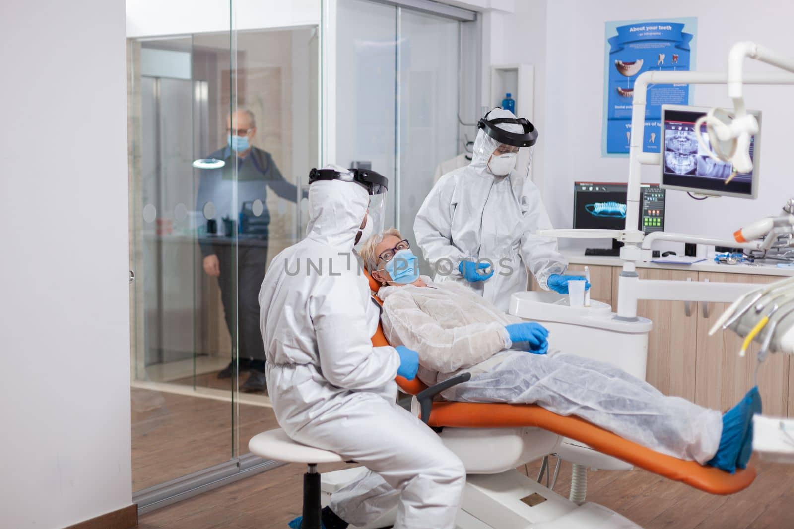 Senior patient wearing hazmat suit during coronavirus by DCStudio