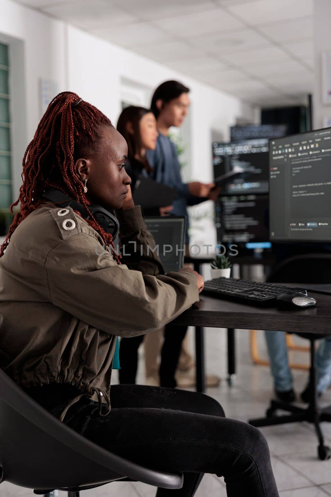 Pensive african american app developer programming code development trying to think at ideas to create coding script. It engineer working at database server in it big data agency office
