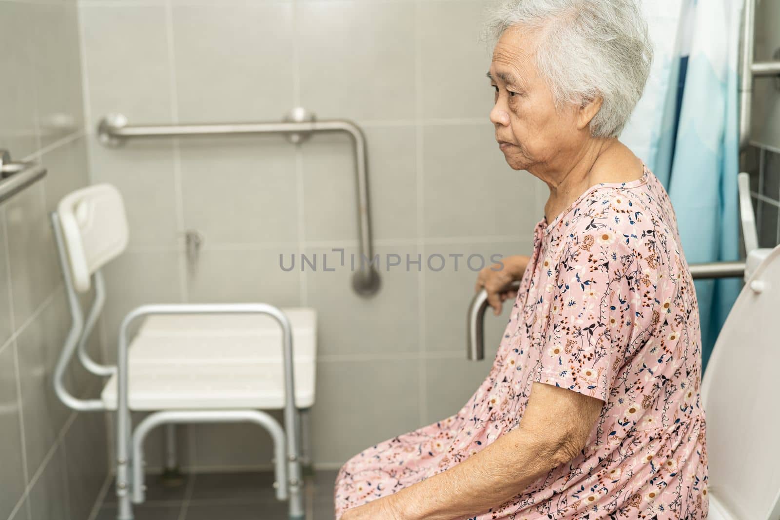 Asian senior or elderly old lady woman patient use toilet bathroom handle security in nursing hospital ward, healthy strong medical concept.