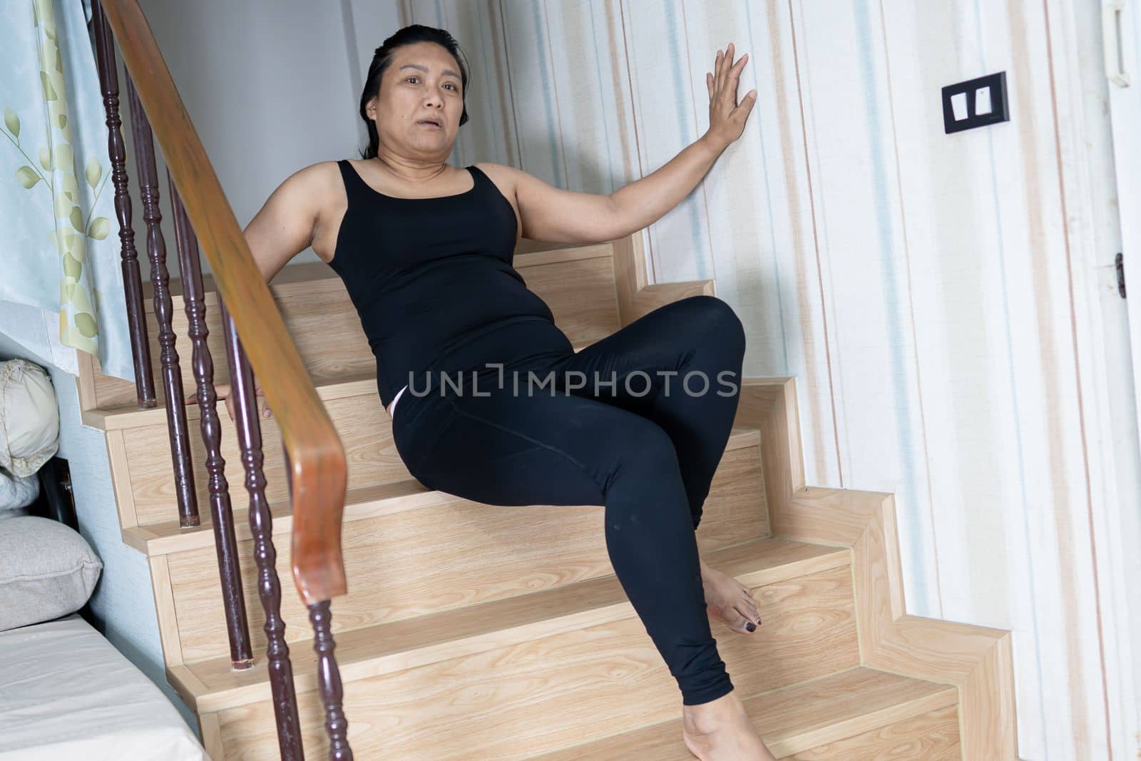 Asian middle-aged lady woman patient fall down the stairs because slippery surfaces by pamai