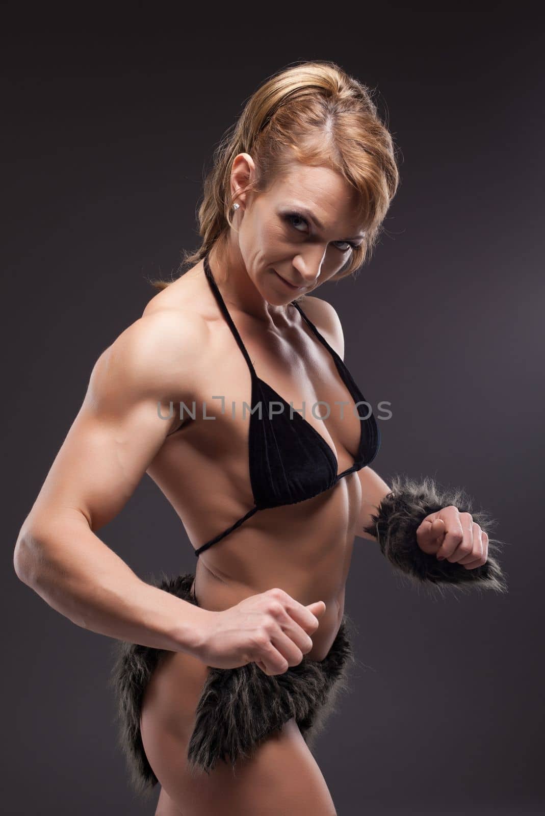 Strong athletic woman body builder posing by rivertime