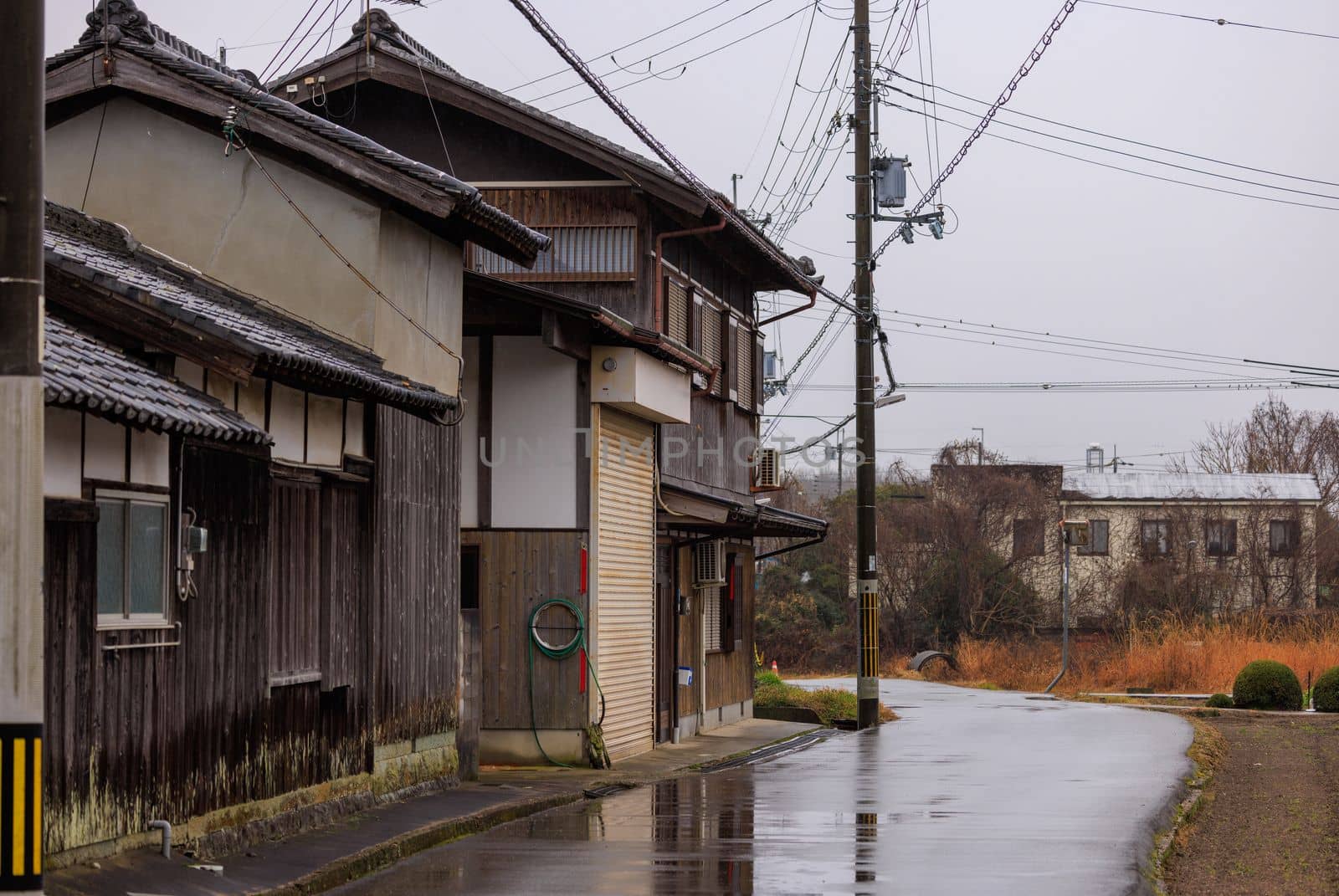 Old wooden Japanese house in rural village on a rainy day. High quality photo