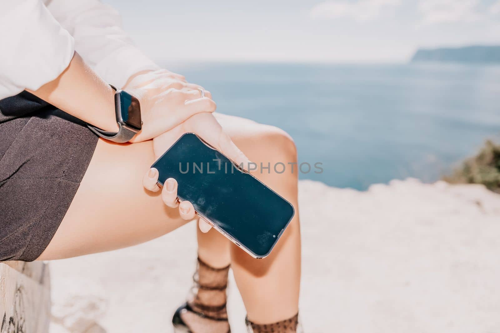 Happy girl doing yoga with laptop working at the beach. beautiful and calm business woman sitting with a laptop in a summer cafe in the lotus position meditating and relaxing. freelance girl remote work beach paradise