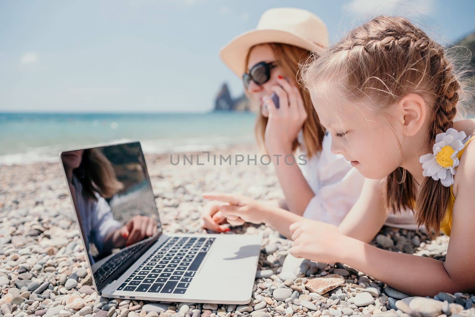 Woman sea laptop. Business woman in yellow hat working on laptop by sea. Close up on hands of pretty lady typing on computer outdoors summer day. Freelance, digital nomad, travel and holidays concept.