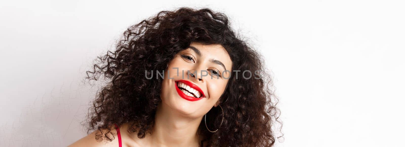 Close-up portrait of happy beautiful woman with curly hair and red lip, smiling white teeth, express happiness and joy by Benzoix