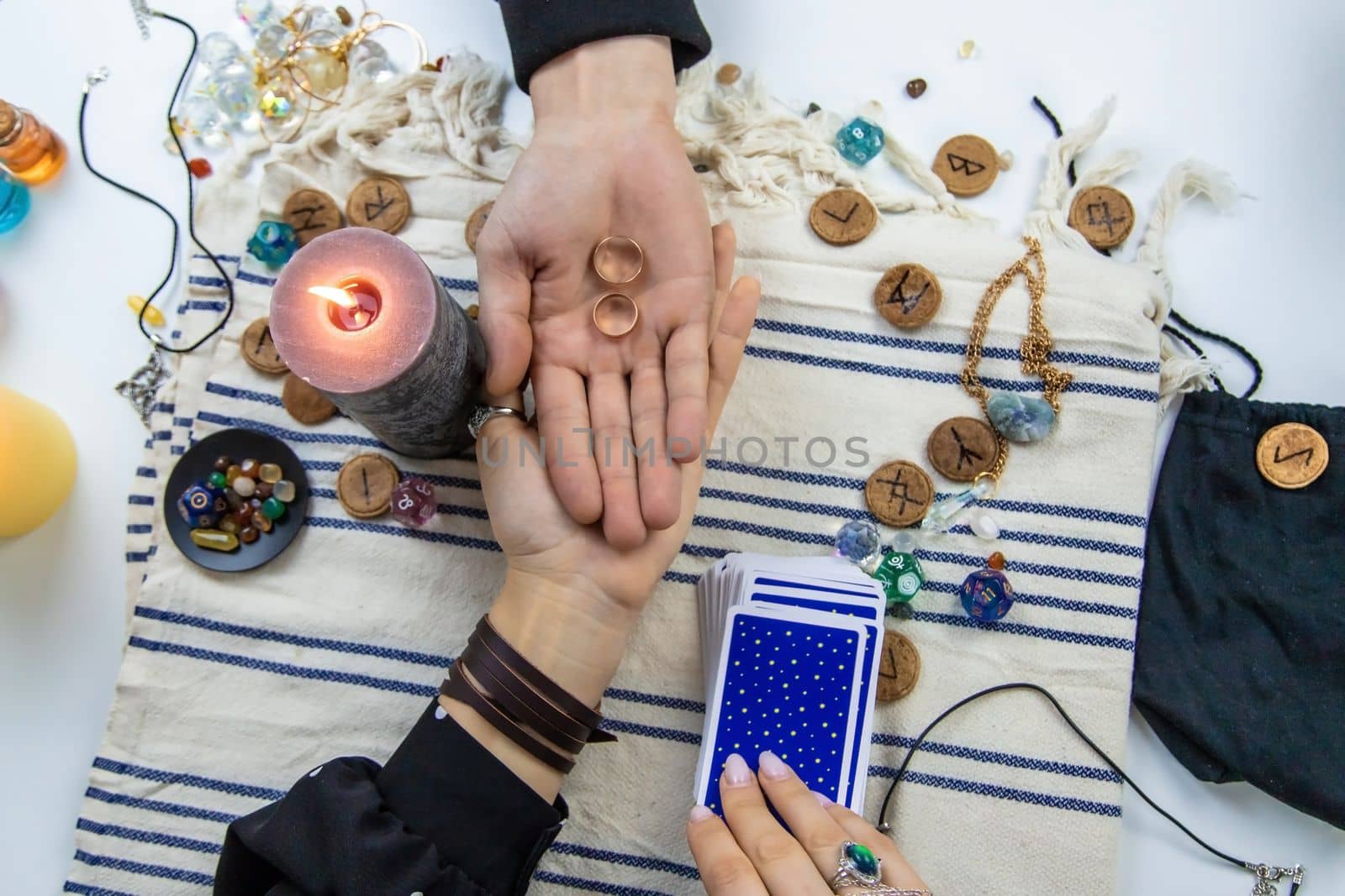 A woman fortuneteller tells a man on tarot cards. Selective focus. People.