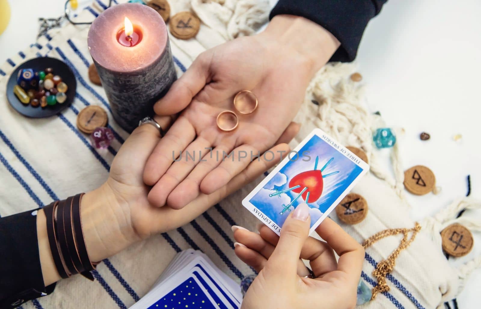 A woman fortuneteller tells a man on tarot cards. Selective focus. People.