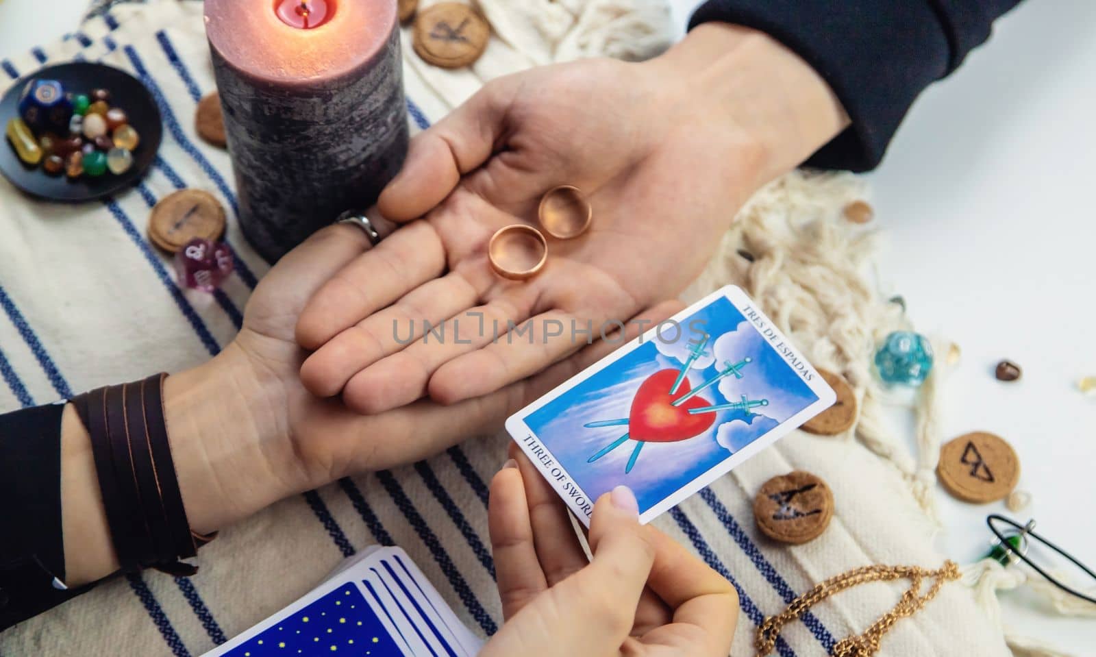 A woman fortuneteller tells a man on tarot cards. Selective focus. People.