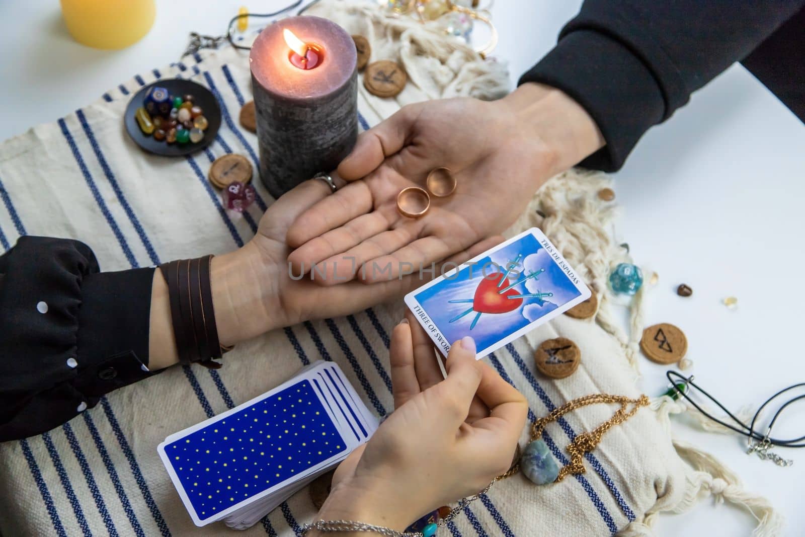 A woman fortuneteller tells a man on tarot cards. Selective focus. People.