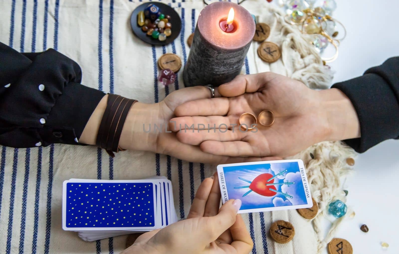 A woman fortuneteller tells a man on tarot cards. Selective focus. People.