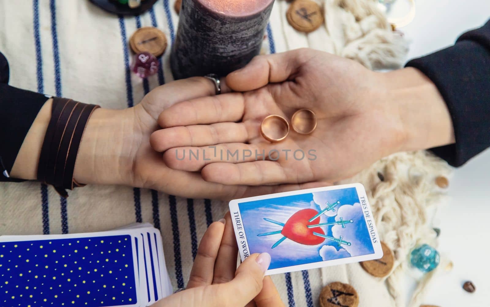A woman fortuneteller tells a man on tarot cards. Selective focus. People.