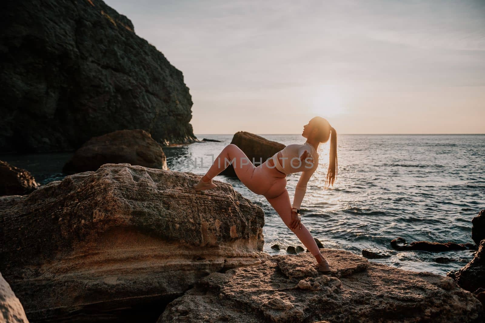 Young woman with black hair, fitness instructor in pink leggings by panophotograph