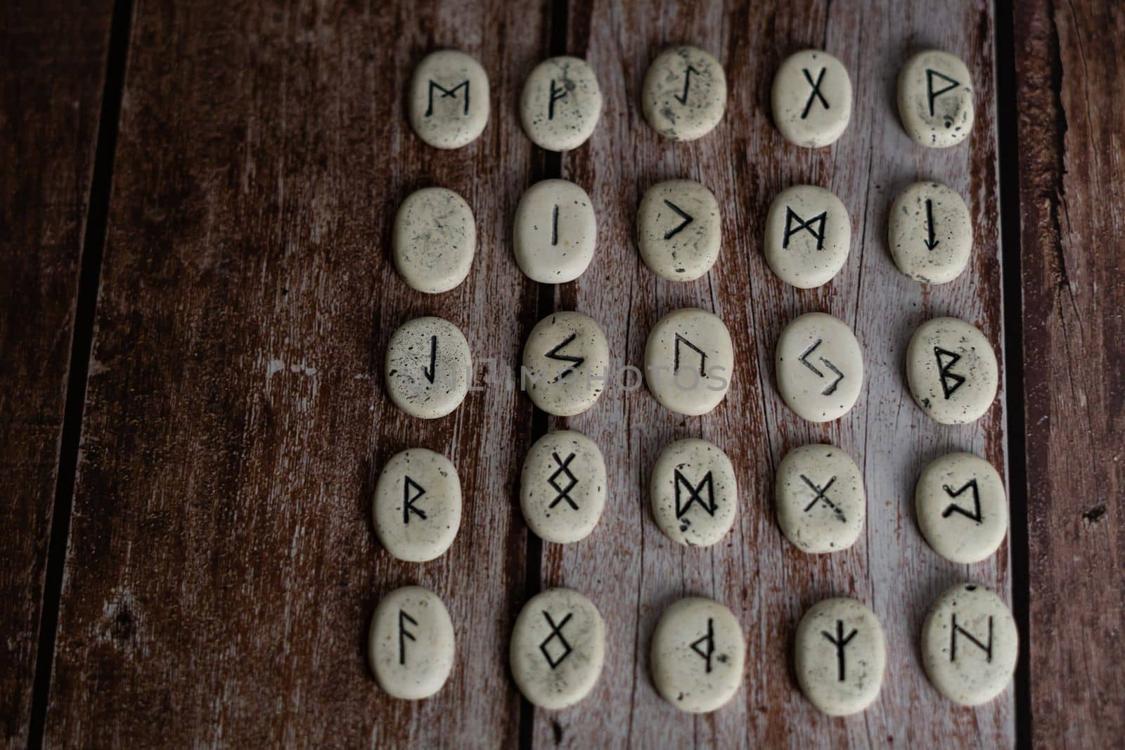 rune stones with black symbols for fortune telling by joseantona