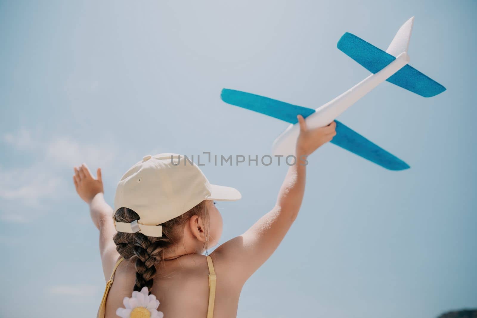 Kid playing with toy airplane. Children dream of travel by plane by panophotograph