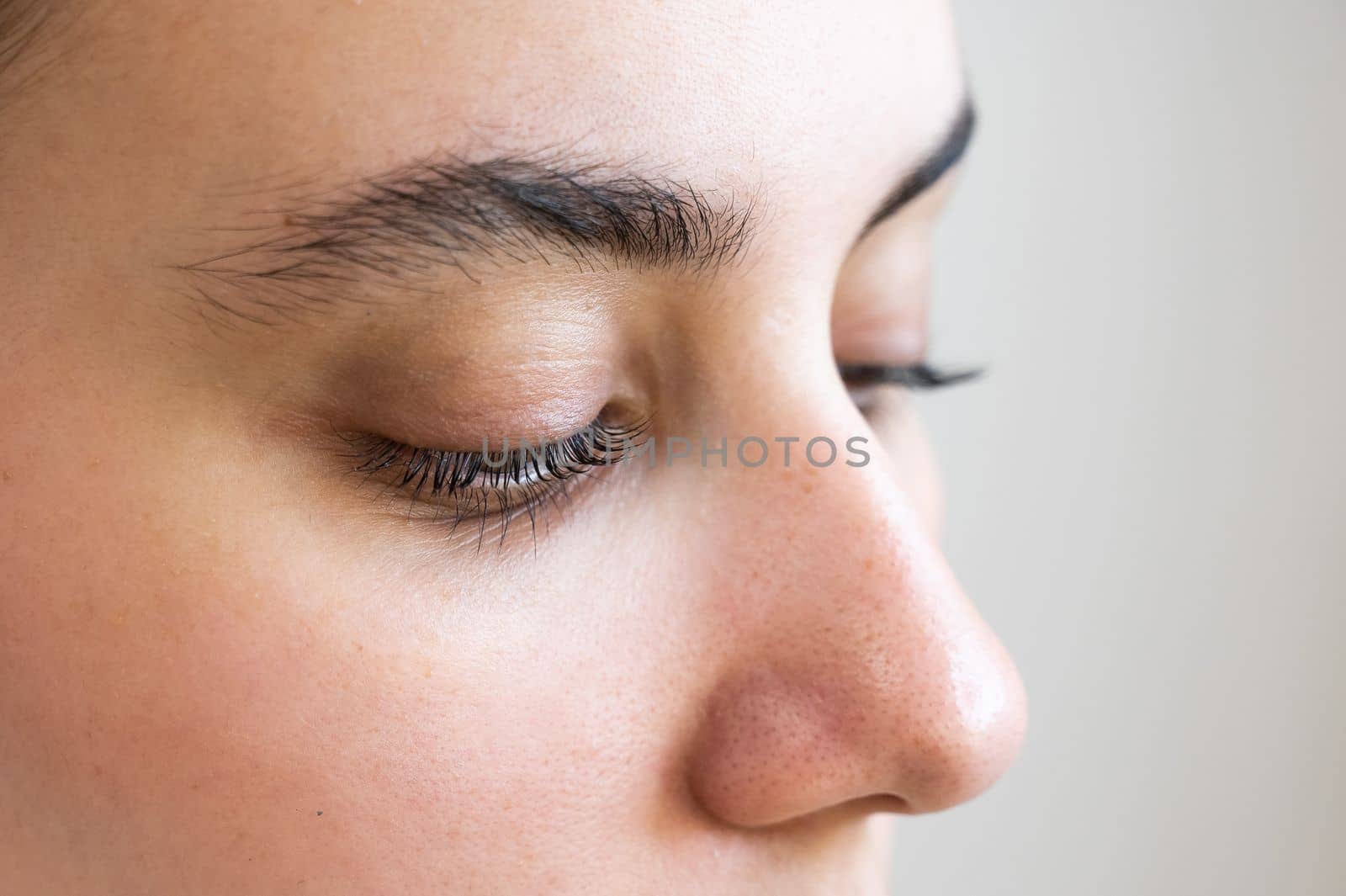 Close-up of a caucasian woman after eyelash lamination procedure