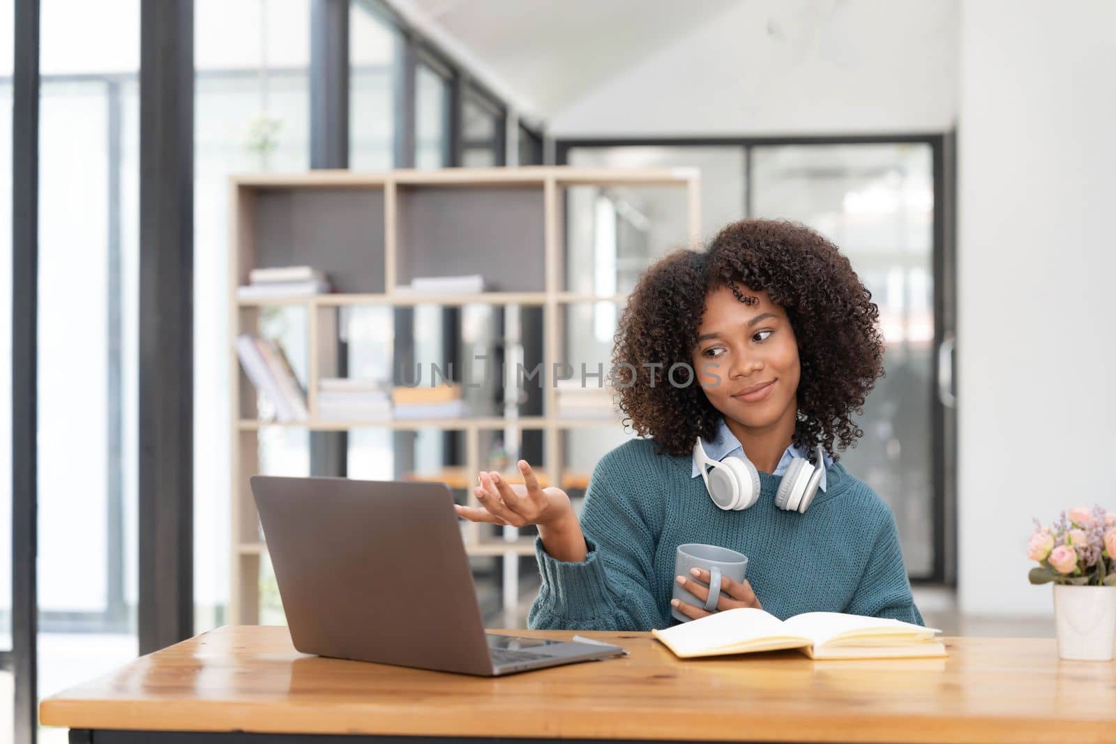 Young asian woman wearing headset working on computer laptop at house. Work at home, Video conference, Video call, Student learning online class..