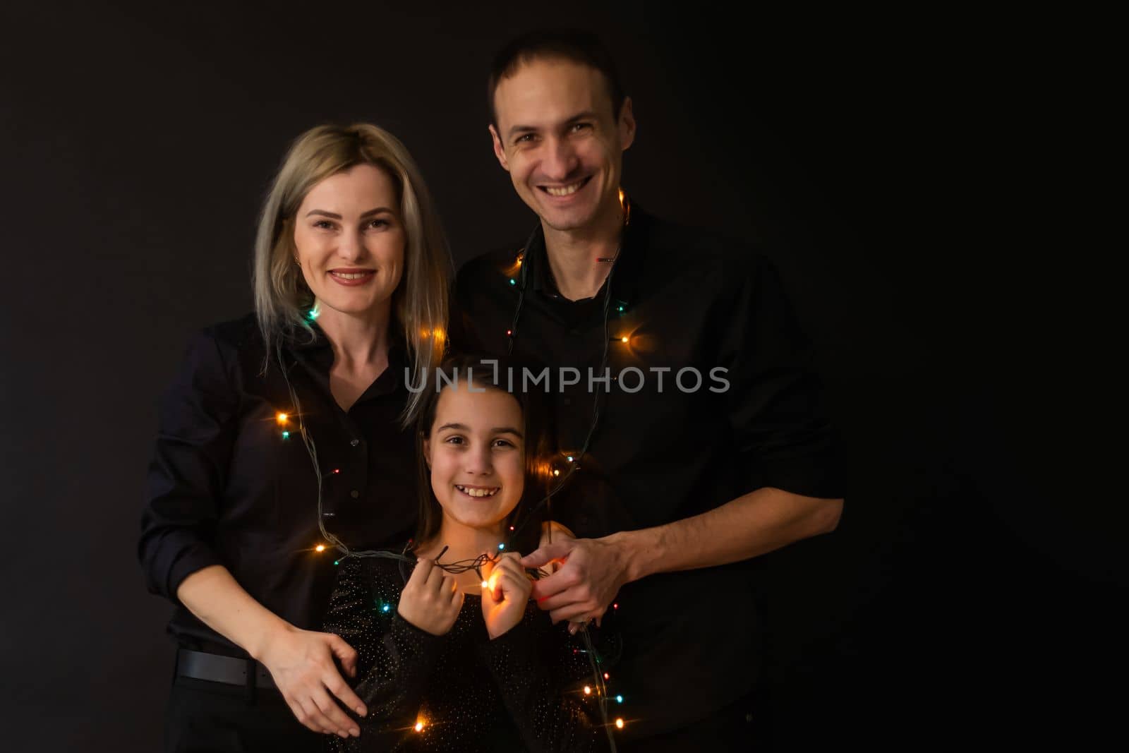 family with garland on a black background.