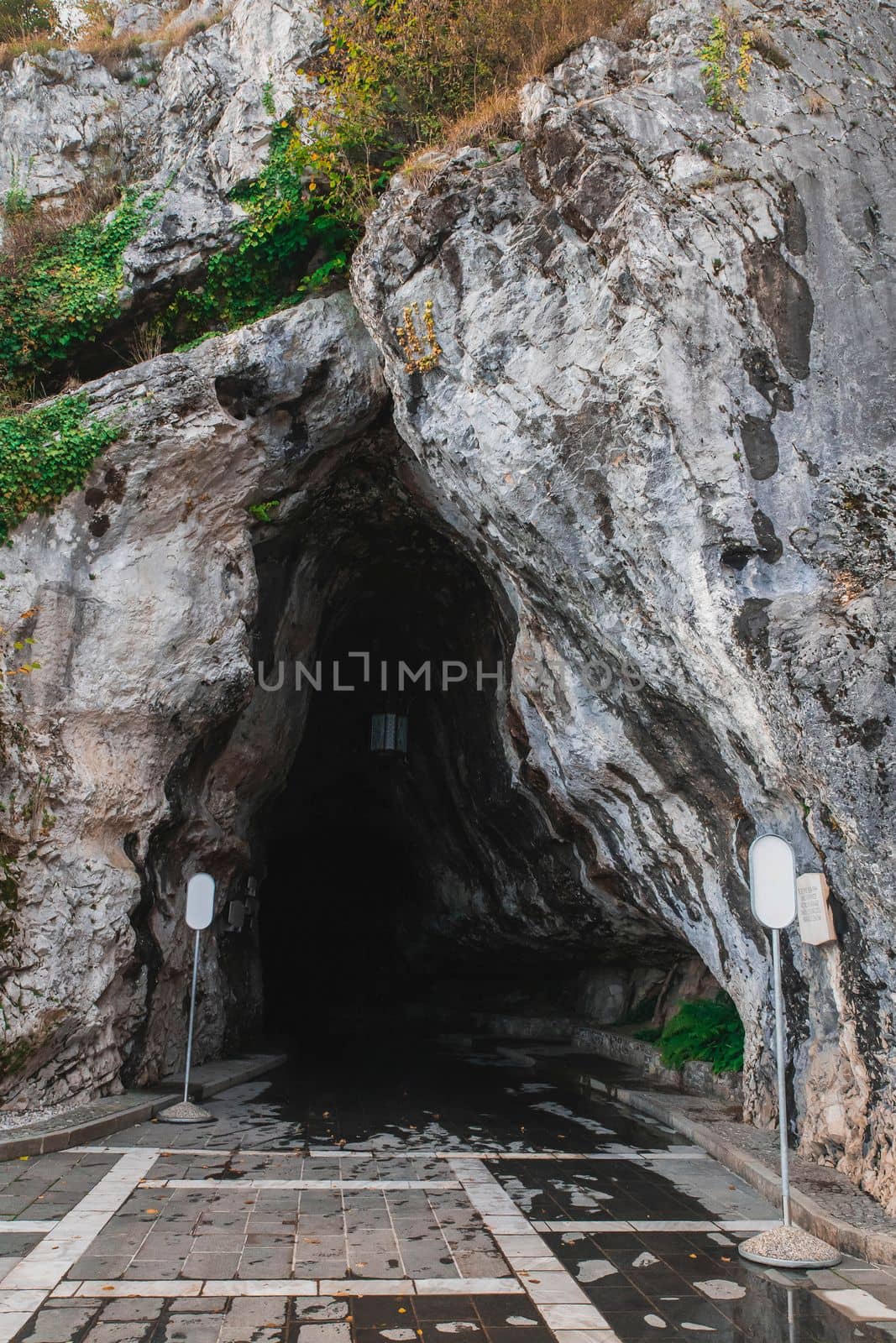 Karst cave entrance Postojnska-Jama in Slovenia.