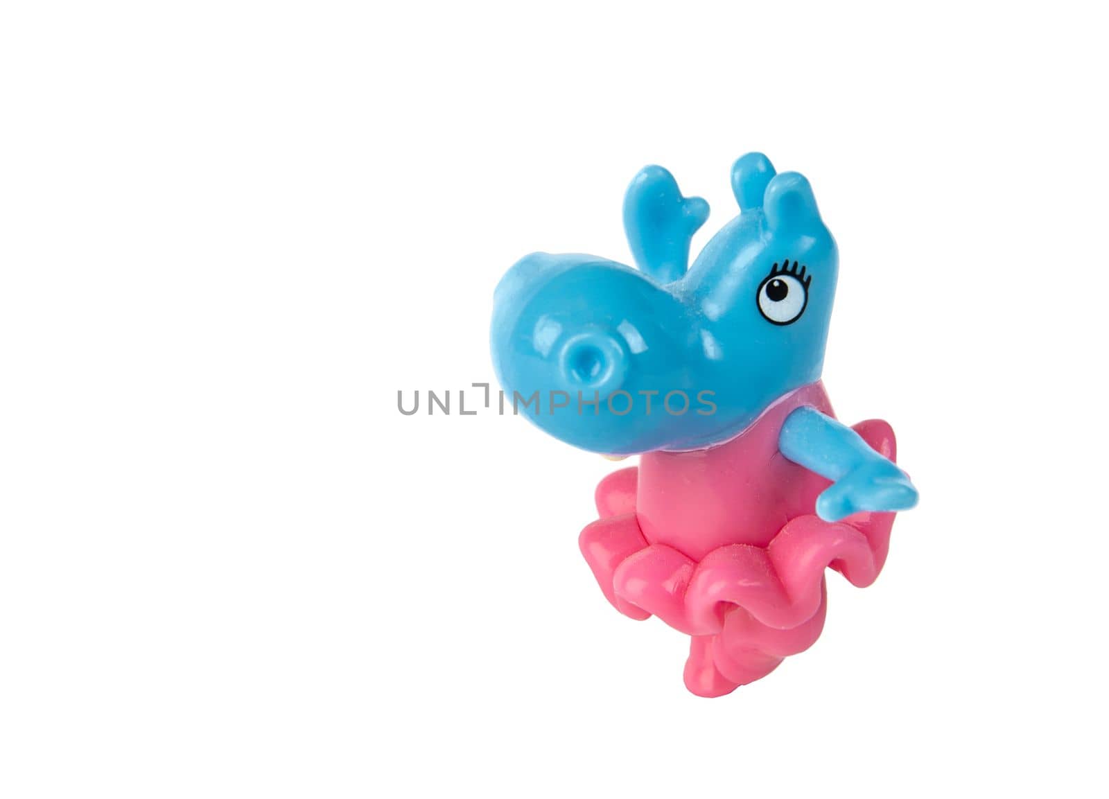 A figure of a dancing hippo in a skirt isolated on a white background. Hippopotamus. Isolate. Children's plastic joke toy.