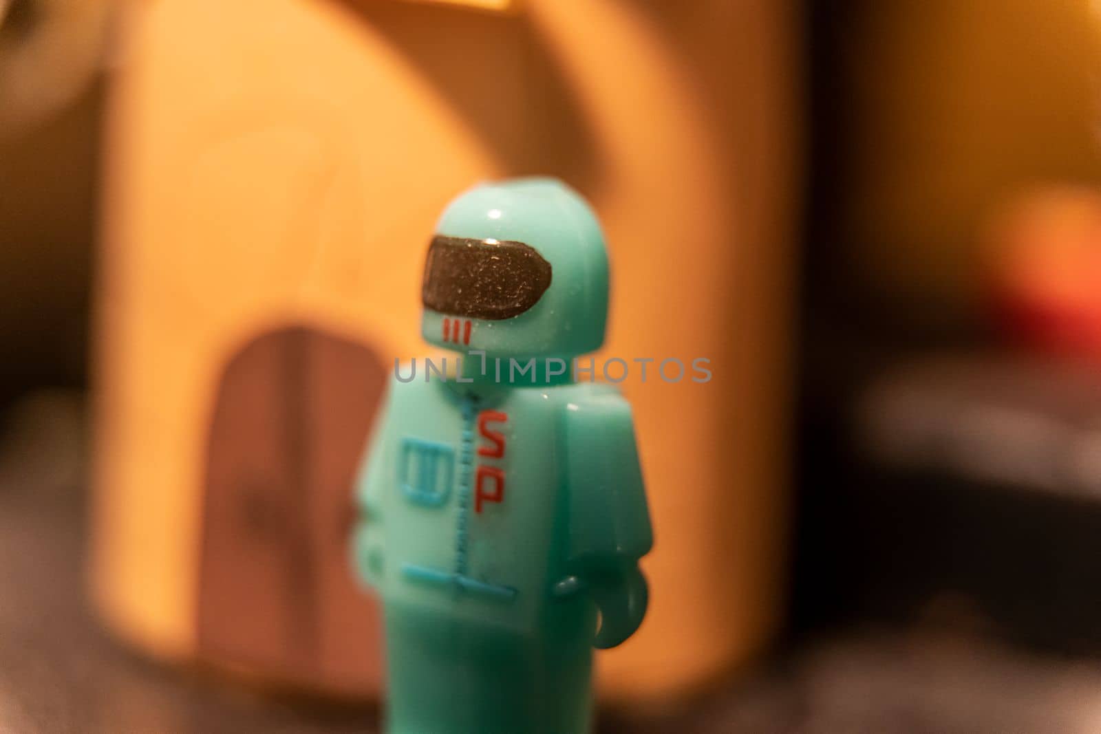 A figure of an astronaut in a space suit and helmet. Space suit. Children's plastic toy. High quality photo